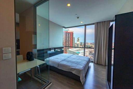 Modern bedroom with city view and ample natural light