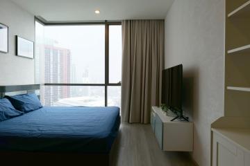 Spacious and modern bedroom with floor-to-ceiling window and city view