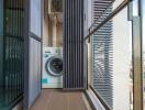 Modern balcony with washing machine and city view