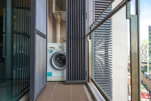 Modern balcony with washing machine and city view