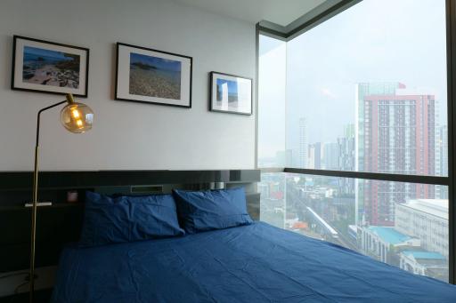 Modern bedroom with large window offering city views