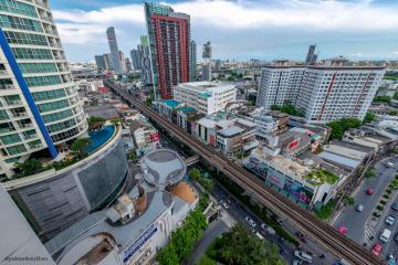 Expansive cityscape view from a high vantage point showcasing various buildings, infrastructure, and urban density