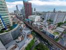 Expansive cityscape view from a high vantage point showcasing various buildings, infrastructure, and urban density