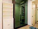 Modern hallway with white storage unit and glass doors