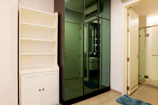 Modern hallway with white storage unit and glass doors