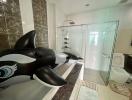 Spacious bathroom with modern fixtures and an inflatable whale toy