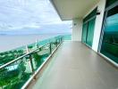Spacious balcony with ocean view and glass railing