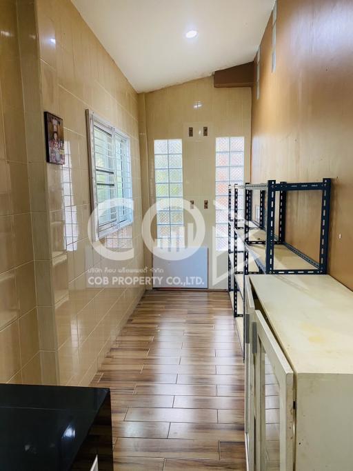 Compact kitchen with tiled flooring and ample cabinets