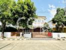 residential house exterior with garden and fence