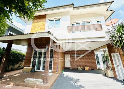 Modern two-story house with a carport and balcony