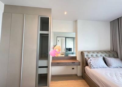Cozy modern bedroom with double bed and built-in wardrobe