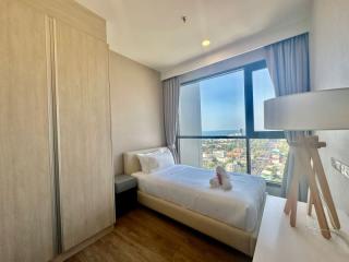 Bright bedroom with a large window offering city views