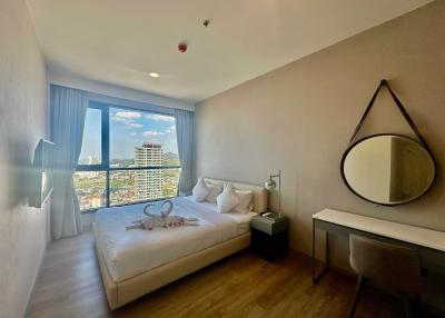 Bright bedroom with city view from a high-rise apartment