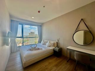 Bright bedroom with city view from a high-rise apartment