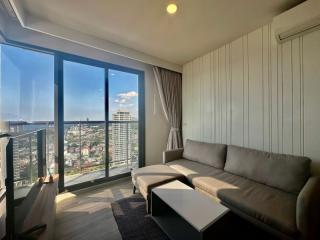 Bright and modern living room with large windows offering a city view