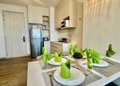 Modern kitchen with dining area including a well-equipped kitchenette and a stylish dining table set