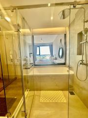 Modern bathroom with glass shower enclosure and external window