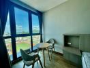 Modern bedroom with a view, featuring a round table and comfortable seating