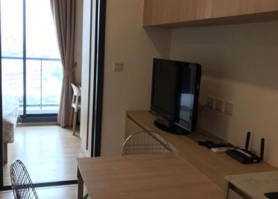 Modern living room with dining table and television