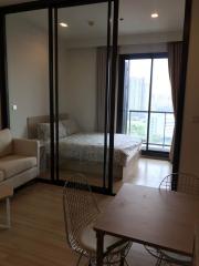 Modern apartment living area with a view into the bedroom