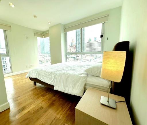 Spacious and well-lit bedroom with a city view