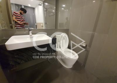 Modern bathroom interior with a person reflected in mirror