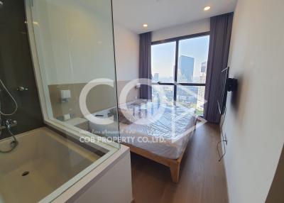 Modern bedroom with en-suite bathroom and city view