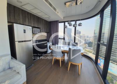 Modern living room with kitchenette and panoramic city view