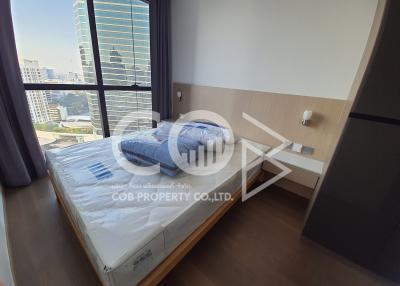 Compact bedroom with city view and natural lighting