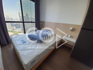 Compact bedroom with city view and natural lighting