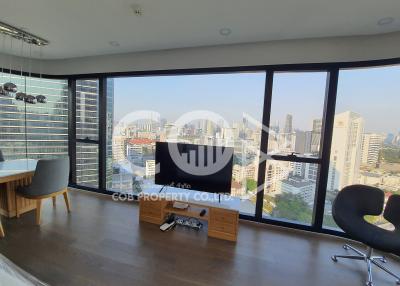 Spacious living room with large windows overlooking the city
