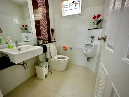 Modern bathroom with white fixtures and mosaic accent wall