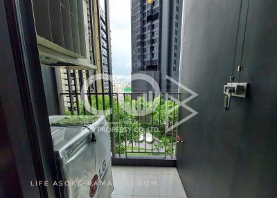 Compact balcony with urban view and green plants