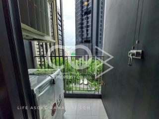 Compact balcony with urban view and green plants