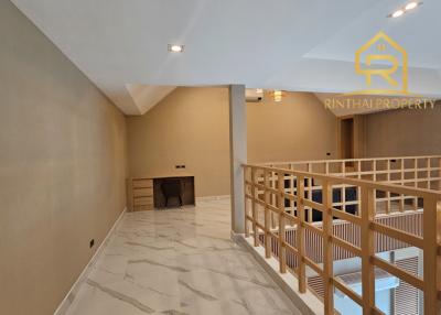Spacious interior hallway with marble flooring and wooden railing