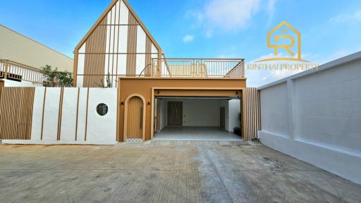 Modern single-family home exterior with spacious driveway and balcony