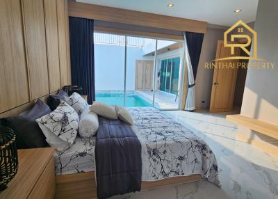 Modern bedroom with king-sized bed and pool view