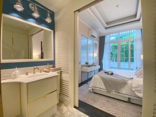Elegant bedroom with en-suite bathroom and french doors leading to outdoor area