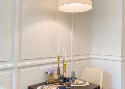 Elegant dining area with modern hanging light fixture and table set for a meal