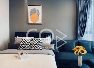 Cozy bedroom with a comfortable bed, modern artwork, and elegant decor