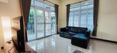 Spacious living room with large windows and modern furniture