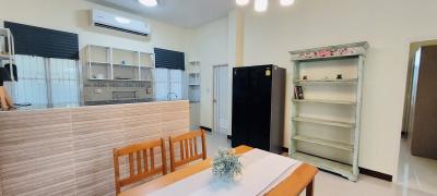 Modern kitchen with dining area, fully equipped with appliances