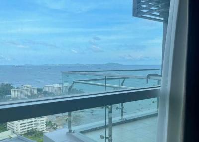 Balcony view of a coastal cityscape with a clear sky