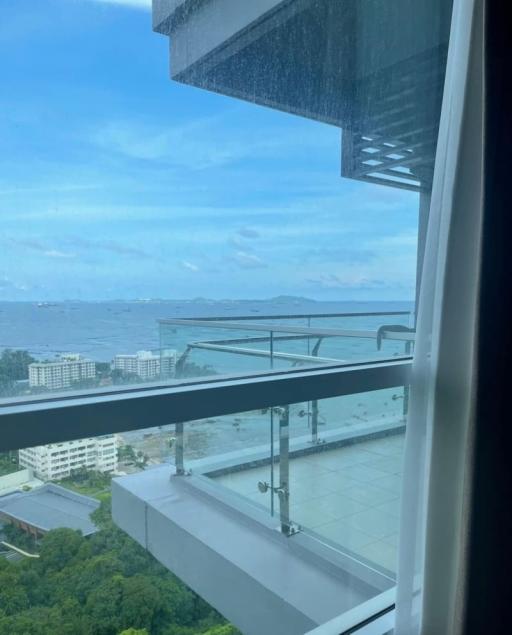 Balcony view of a coastal cityscape with a clear sky