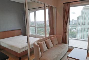 Modern bedroom with a large window and city view