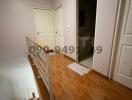 Interior hallway in building with wooden floors and doors leading to various rooms