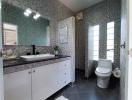 Modern bathroom with double vanity and patterned wall tiles