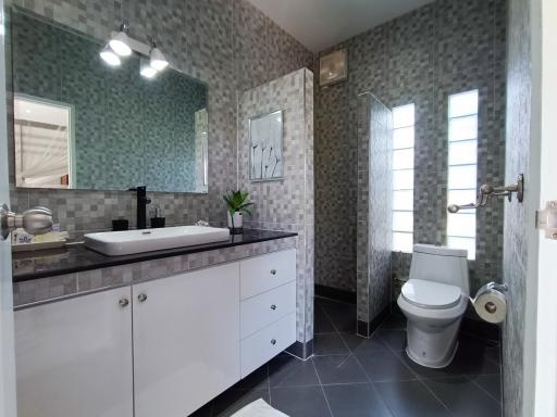 Modern bathroom with double vanity and patterned wall tiles