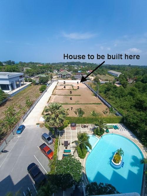 Aerial view of a vacant lot near a swimming pool ready for house construction