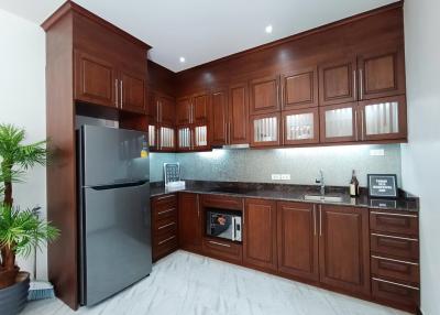 Modern kitchen with wooden cabinets and stainless steel appliances